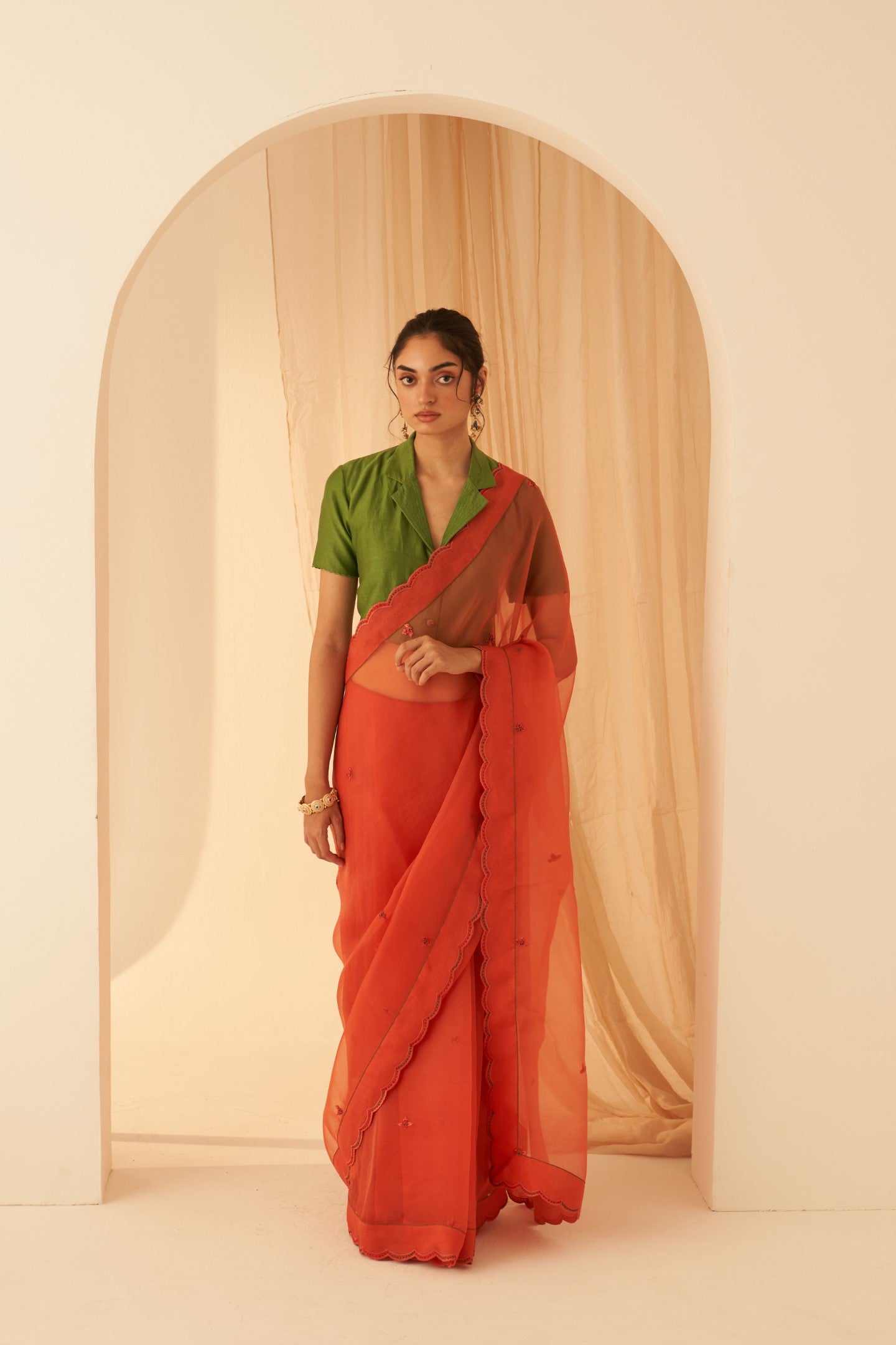 Rust organza allover embroidered butis with beautiful scallop border saree paired with an organic cotton stitched petticoat