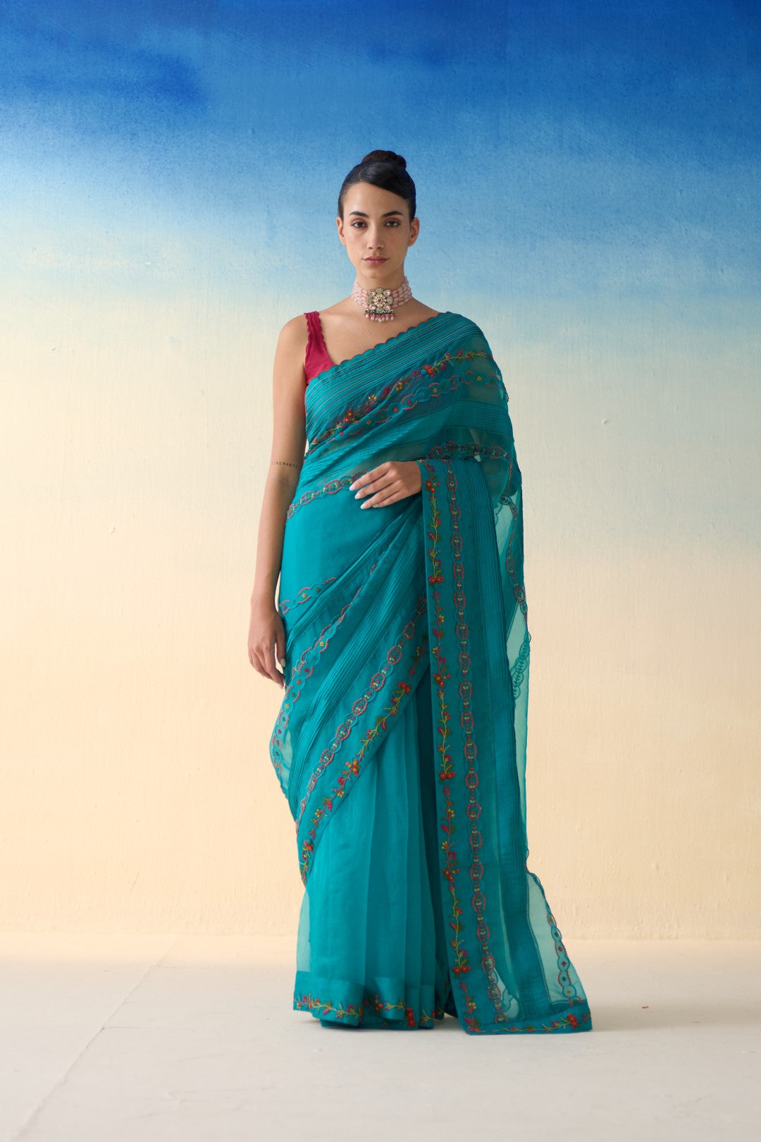 Turquoise silk multicolor embroidered & scallop work saree comes with an organic cotton stitched petticoat ( 02 Pcs.)