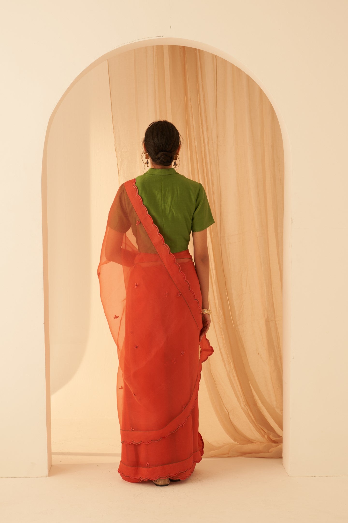 Rust organza allover embroidered butis with beautiful scallop border saree paired with an organic cotton stitched petticoat