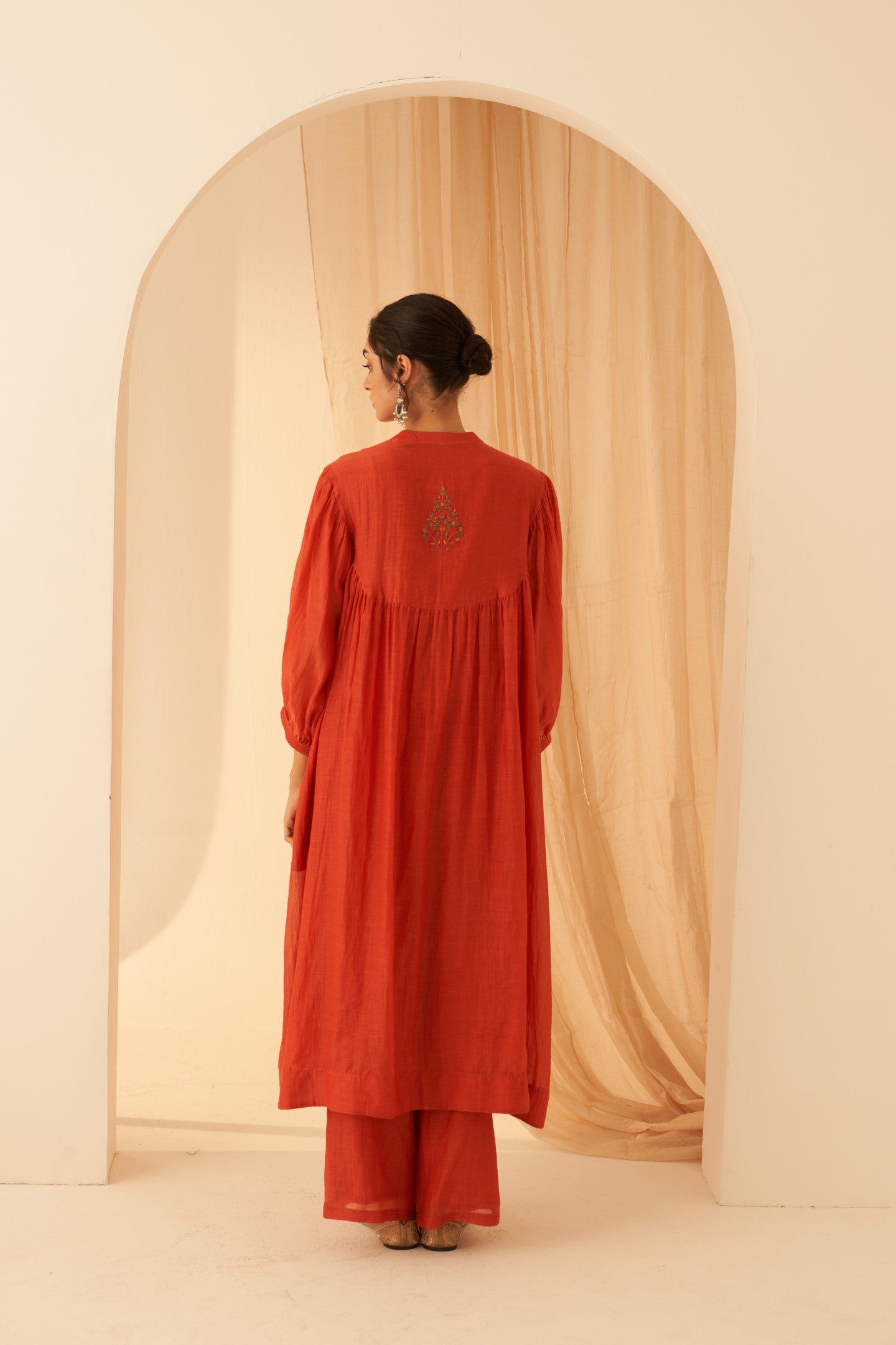 Rust chanderi cross stitch embroidered kurta paired with cotton slip, pant & chanderi dupatta