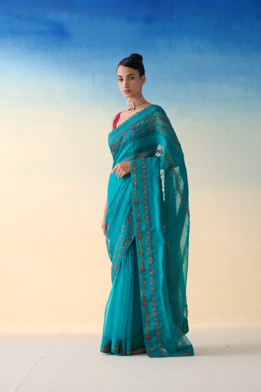 Turquoise silk multicolor embroidered & scallop work saree comes with an organic cotton stitched petticoat ( 02 Pcs.)