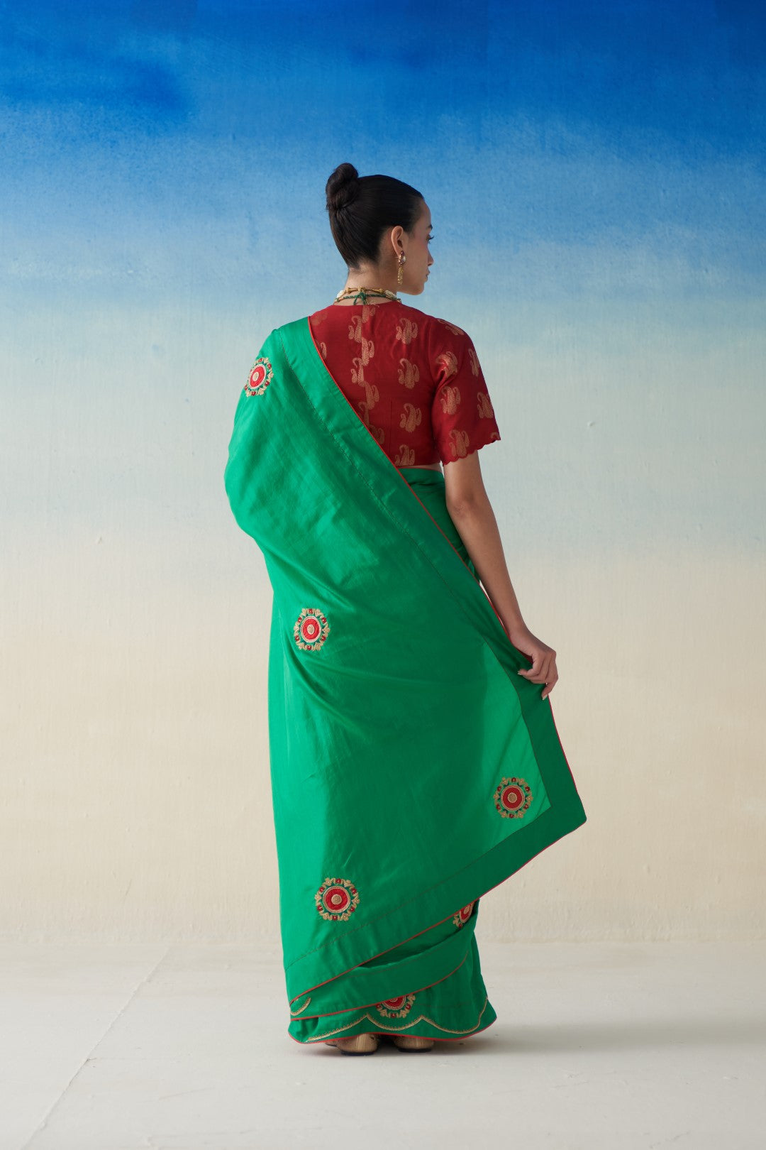 Green silk saree with embroidered motifs comes with an organic cotton stitched peticoat (02 Pcs.)