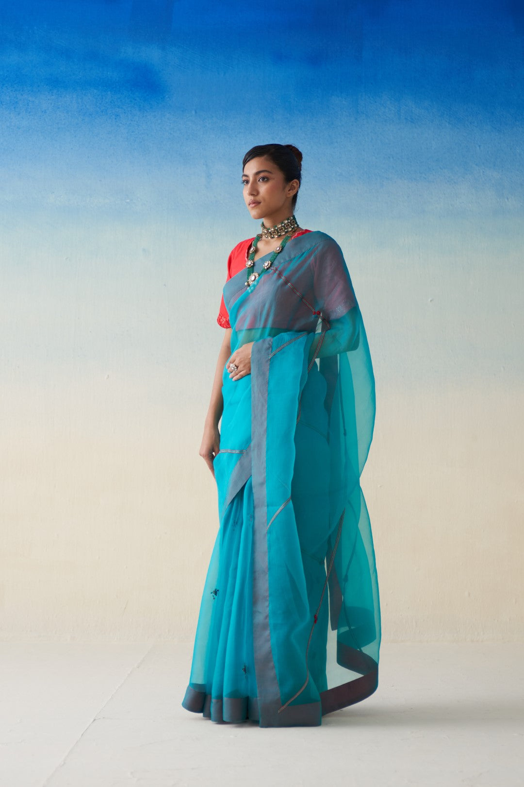 Turquoise  organza  embroidered saree comes with an organic cotton stitched petticoat (02 Pcs.)