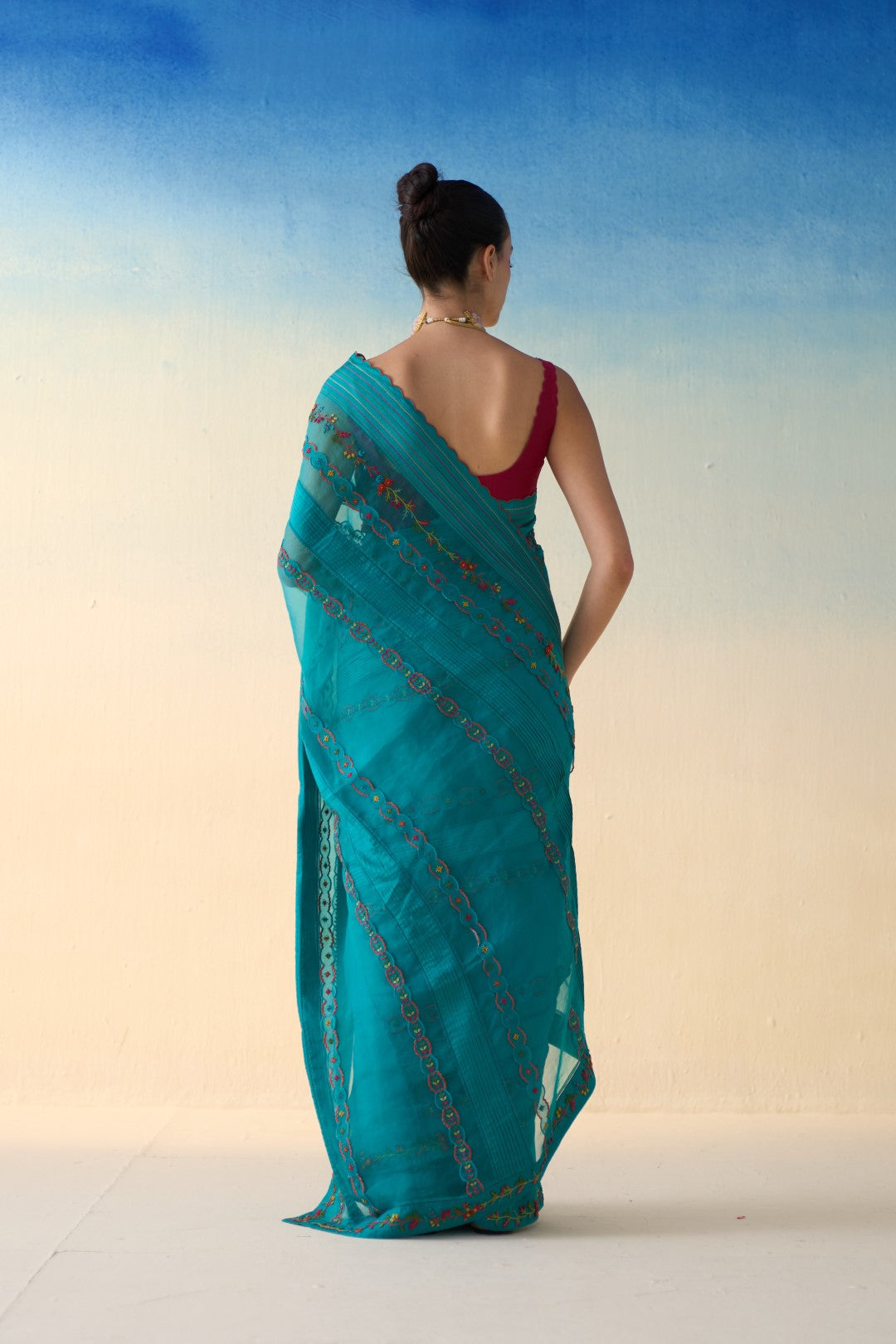 Turquoise silk multicolor embroidered & scallop work saree comes with an organic cotton stitched petticoat ( 02 Pcs.)