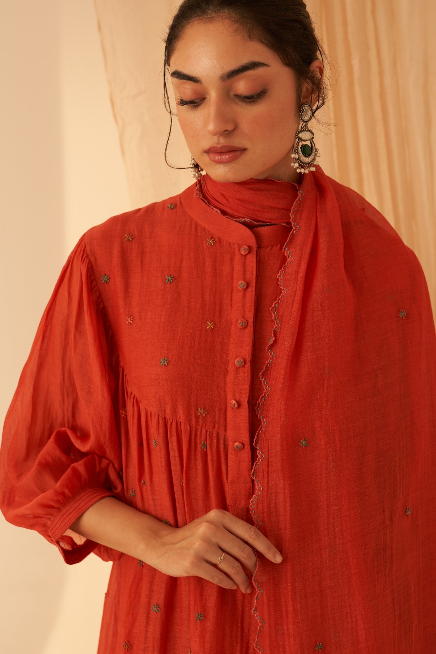 Rust chanderi cross stitch embroidered kurta paired with cotton slip, pant & chanderi dupatta