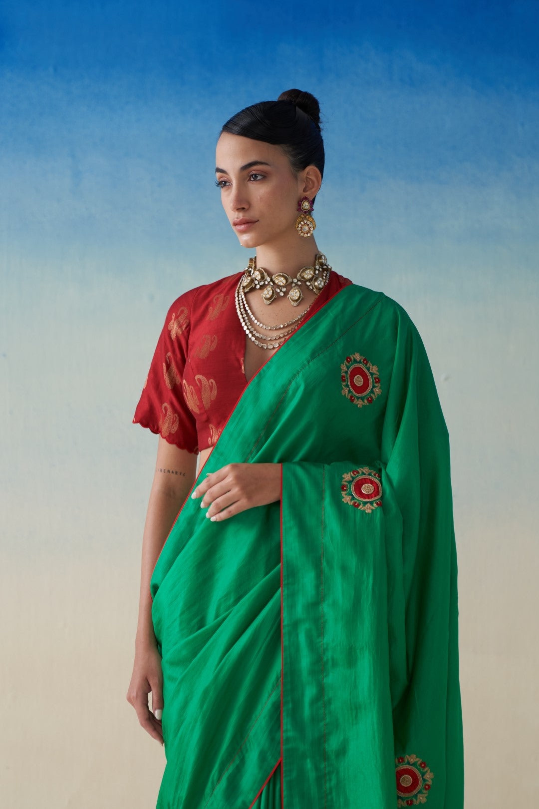 Green silk saree with embroidered motifs comes with an organic cotton stitched peticoat (02 Pcs.)