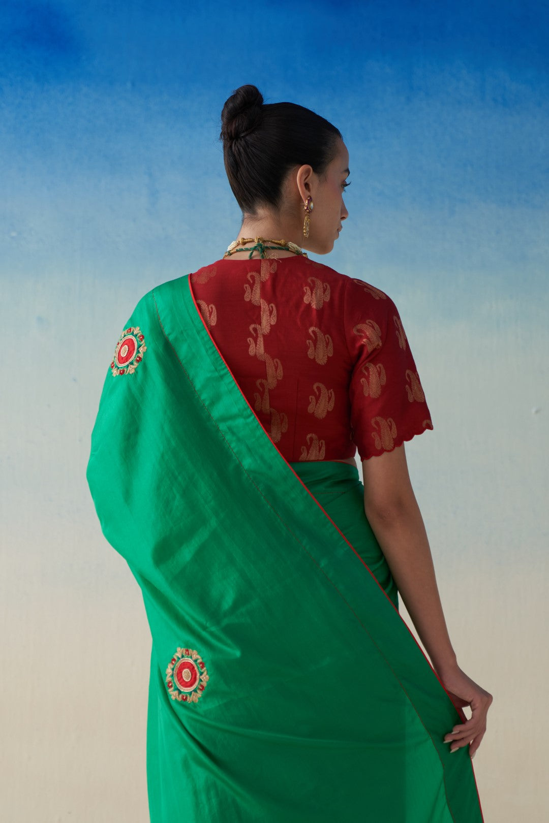 Green silk saree with embroidered motifs comes with an organic cotton stitched peticoat (02 Pcs.)