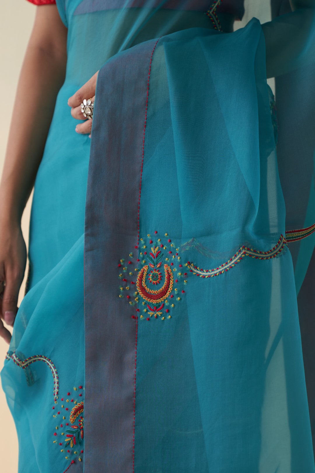 Turquoise organza checkered jaal-embroidered saree comes  with an organic cotton stitched petticoat (02 Pcs.)